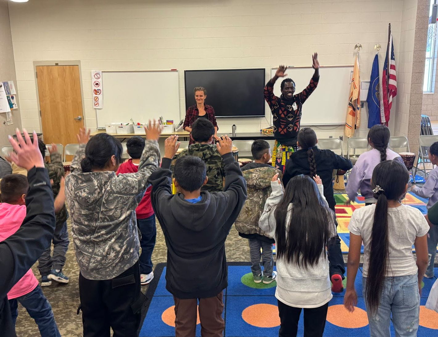 Students and teachers participate in an activity in a classroom.