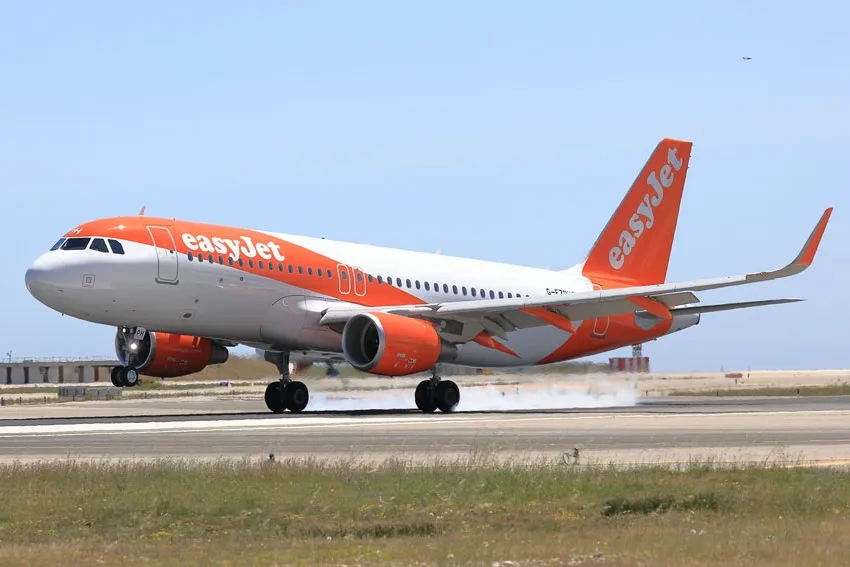 EasyJet A320  taxis along a runway.