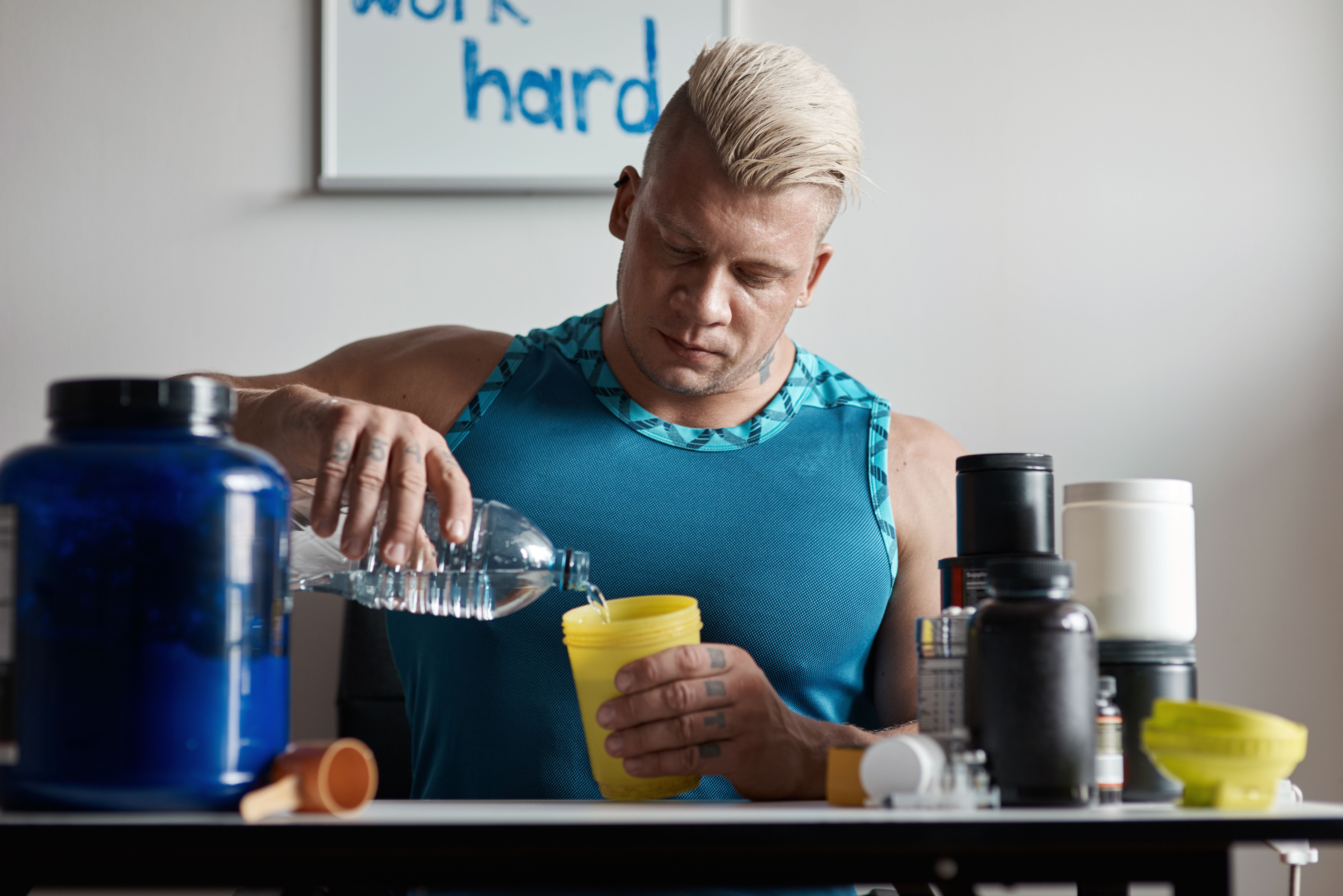 waist-up-of-a-bodybuilder-making-a-protein-drink-2026-01-05-05-57-01-utc