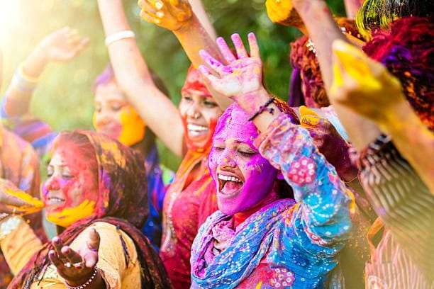 Indian women throwing colored Holi powder Indian women throwing colored Holi powder Vibrant Culture and Festivals stock pictures, royalty-free photos & images