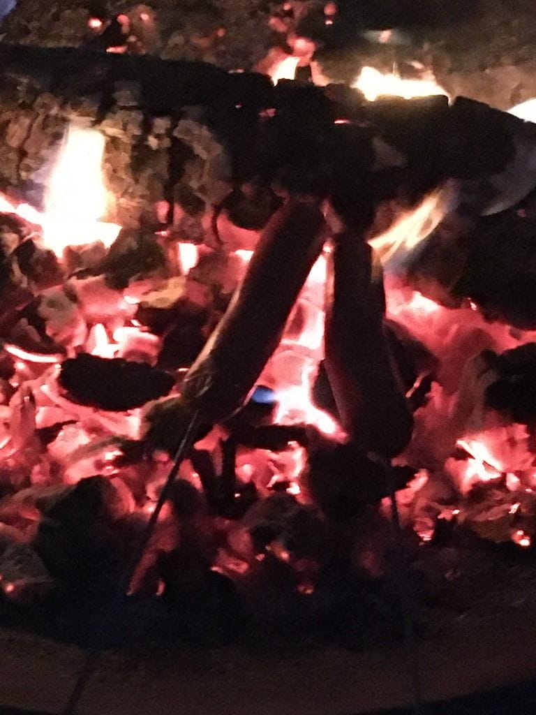 Camp fire with smoldering coals at night