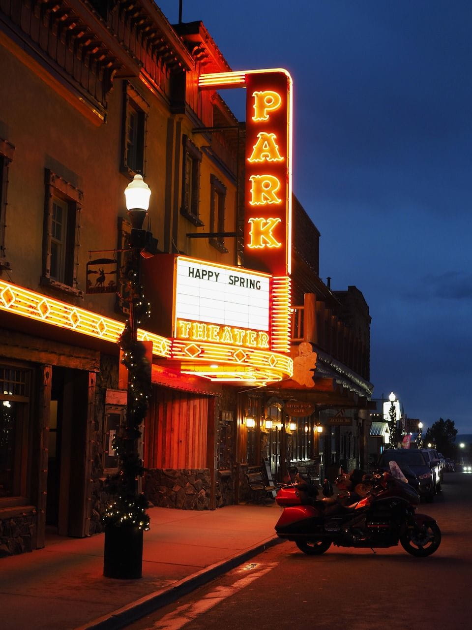 Downtown mainstreet at night in Walden. The sign on the theatre reads "Happy Spring" welcoming visitors to North Park.