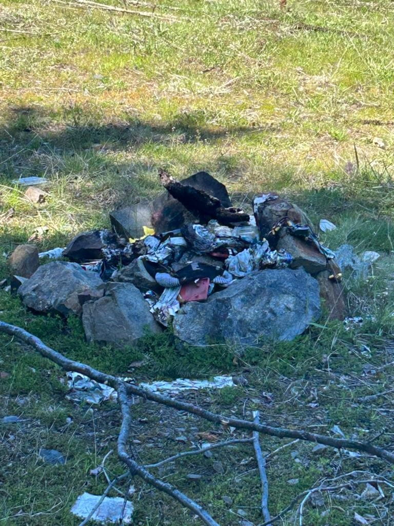 Garbage left in a fire ring.
