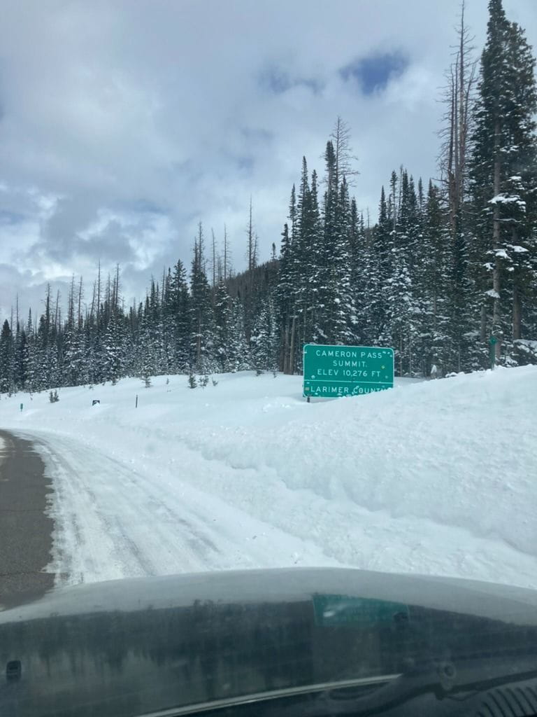 Cameron Pass Summit: Elevation 10,276 FT. Buried road sign in a typical year at the summit.