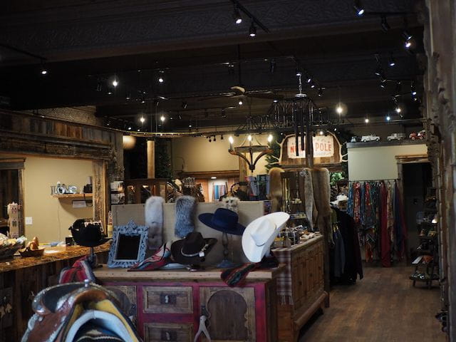 interior view of a boutique store with hats, saddles, and other giftware
