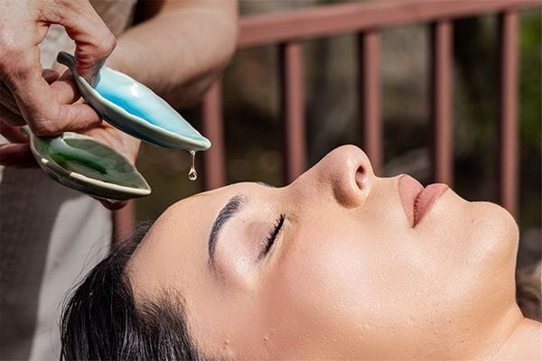 Woman with eyes closed receives a Sedona spa treatment