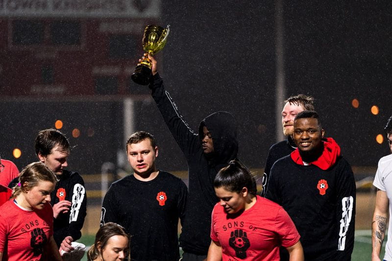 Champions holding up their trophy