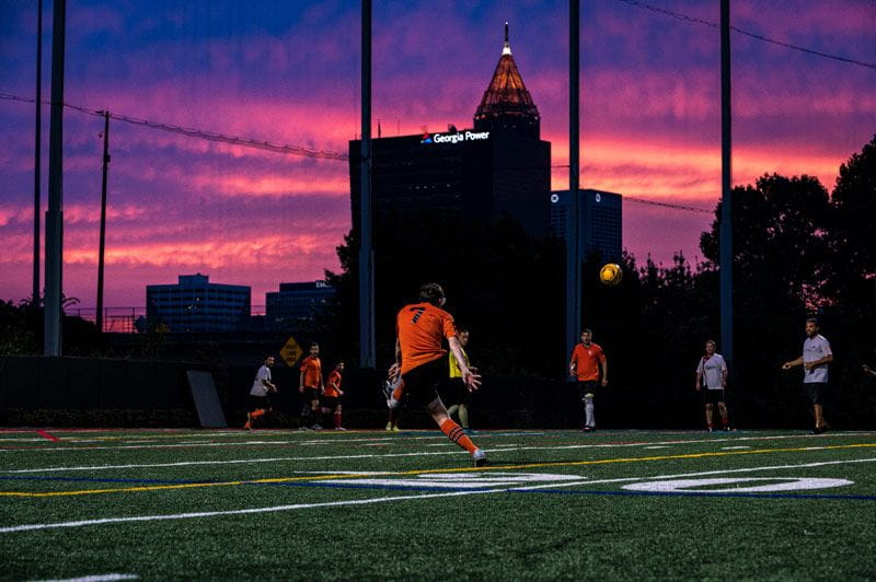 Player on turf field at sunset