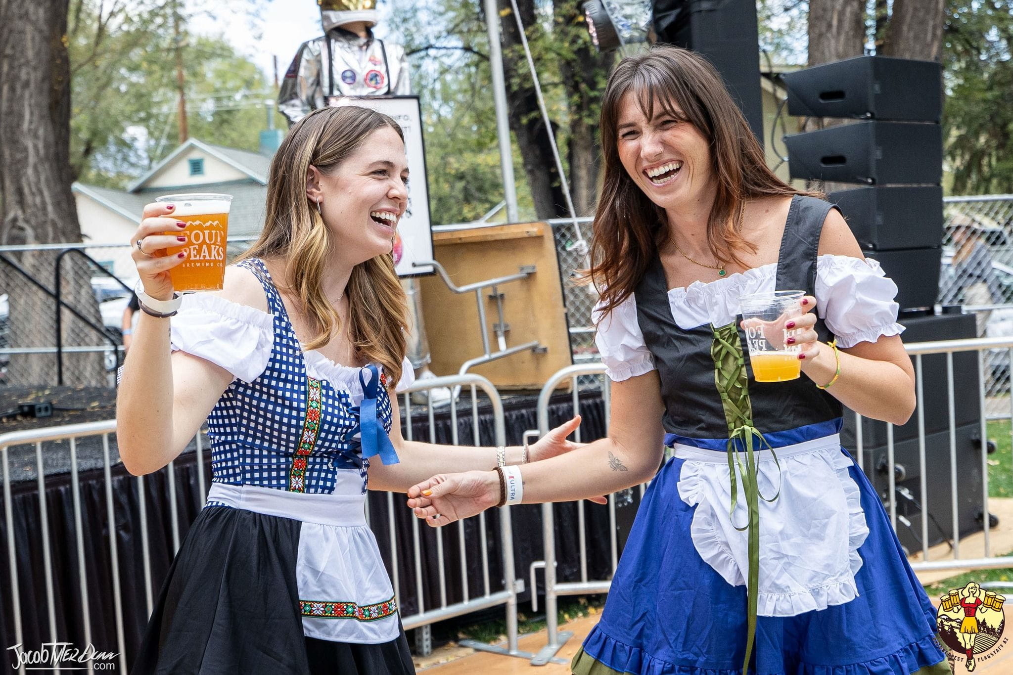 Two women laughing and holding beer