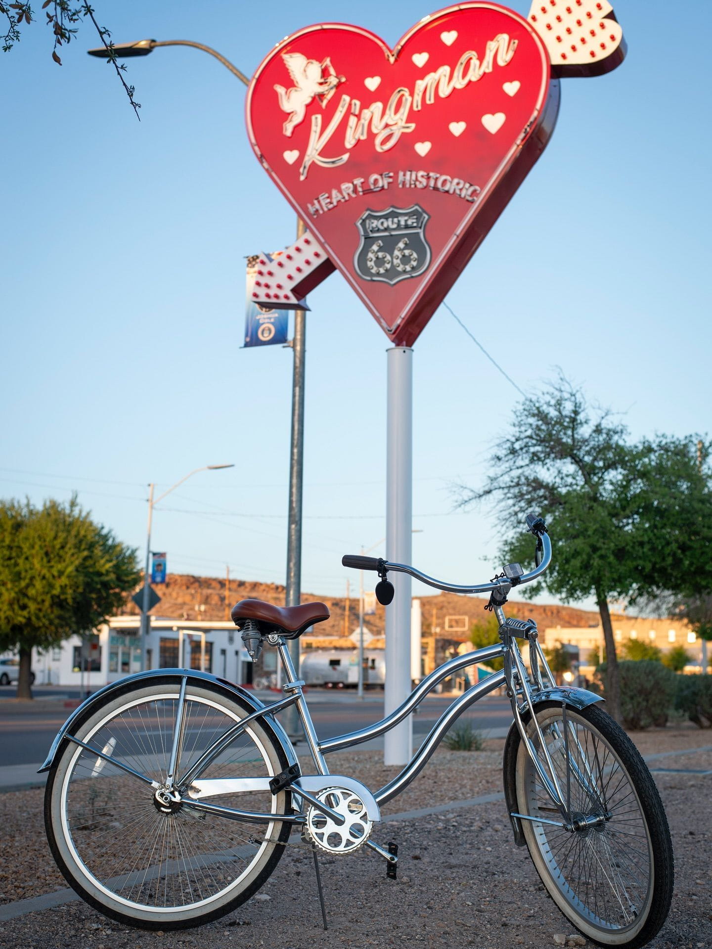vintage bicycle in front of heart neon sign