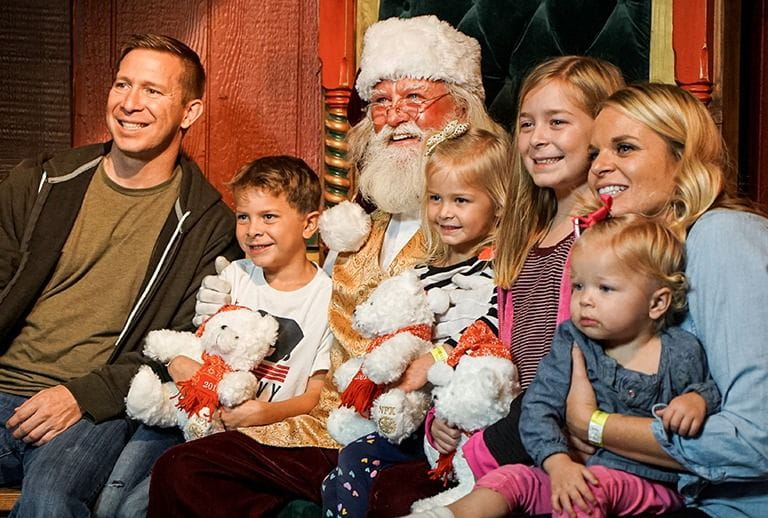 family sitting with santa clause