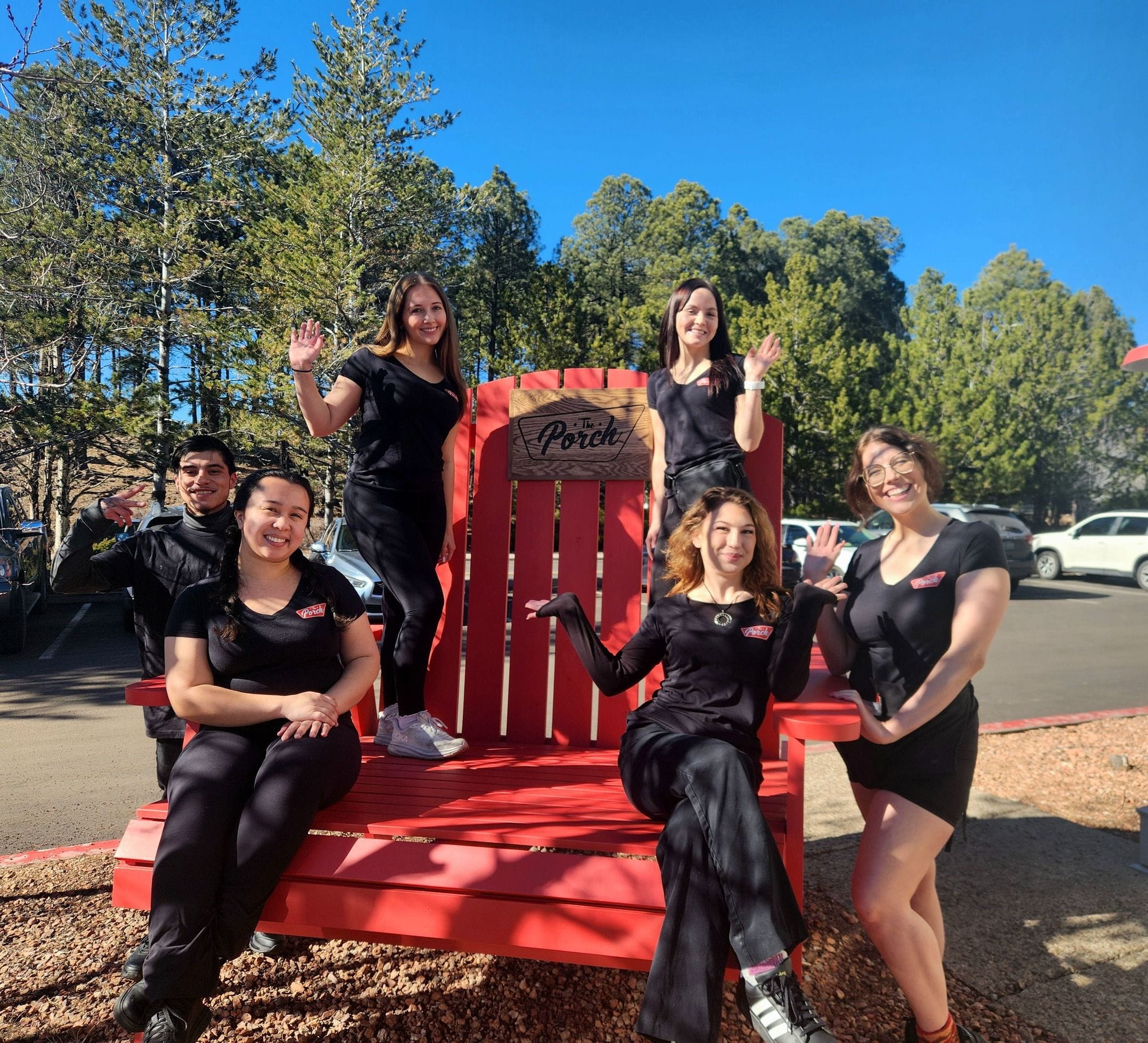 6 people on and around a large patio chairs