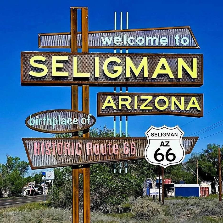 Metal outdoor sign which reads "Welcome to Seligman Arizona birthplace of Historic Route 66"